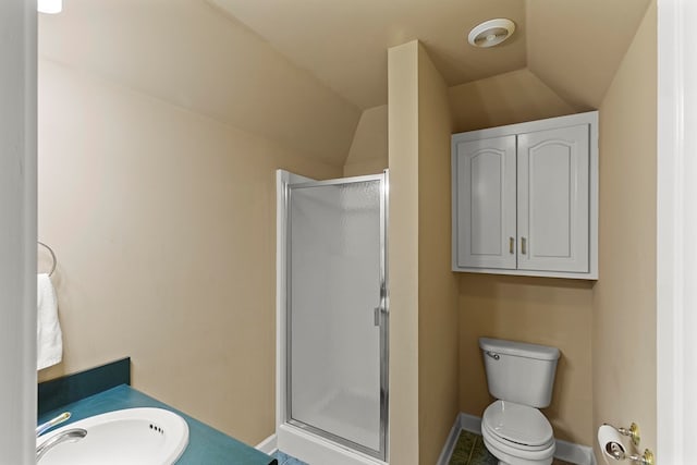 bathroom with toilet, sink, lofted ceiling, and walk in shower