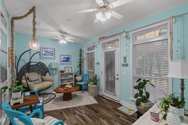 sitting room featuring ceiling fan and dark wood-type flooring