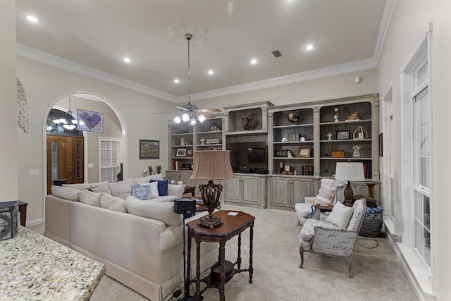 living room with crown molding, light colored carpet, and ceiling fan with notable chandelier