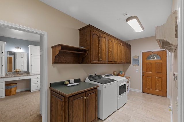 laundry room featuring cabinets, light colored carpet, and washer and dryer