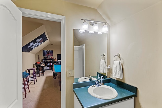 bathroom with vanity and lofted ceiling