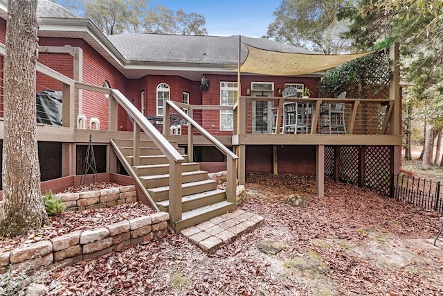 rear view of house featuring a wooden deck