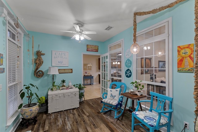 sitting room with french doors, dark hardwood / wood-style floors, and ceiling fan