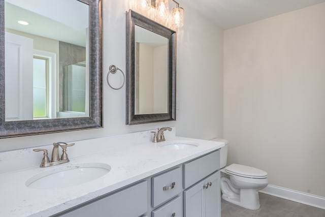 full bathroom featuring toilet, tile patterned flooring, double vanity, and a sink
