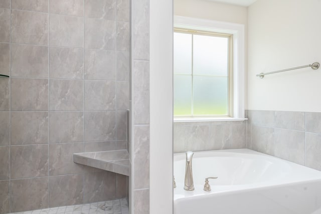 full bath with a garden tub