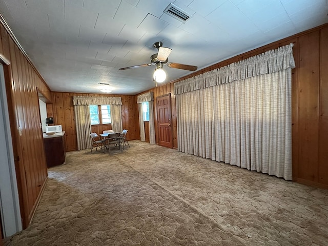 111 Helen St, Dothan, AL 36301 - carpeted dining area with wooden walls and a ceiling fan