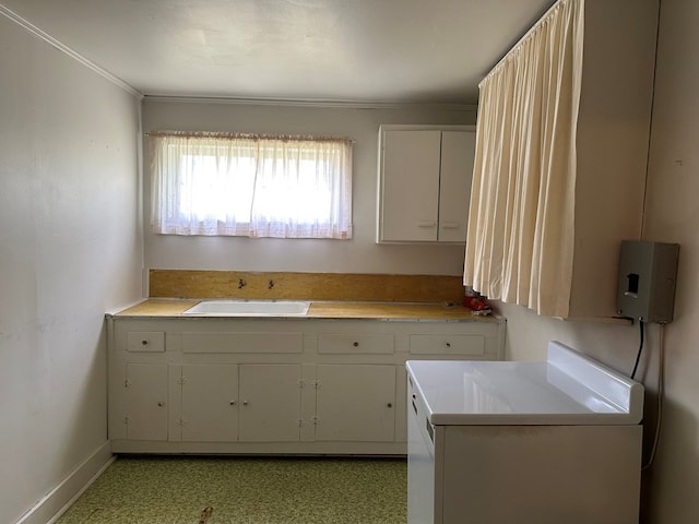 111 Helen St, Dothan, AL 36301 - kitchen with a sink, washer / clothes dryer, light countertops, baseboards, and crown molding