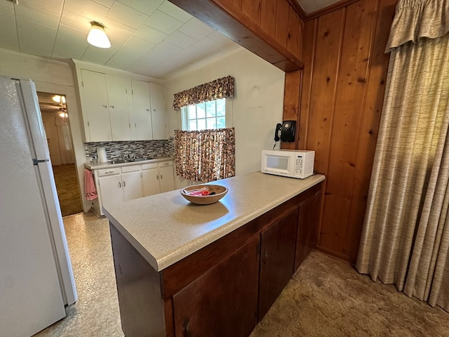 111 Helen St, Dothan, AL 36301 - kitchen featuring white appliances, light countertops, backsplash, a peninsula, and ornamental molding