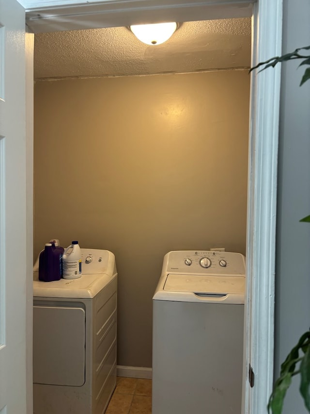 clothes washing area with separate washer and dryer, laundry area, and light tile patterned flooring