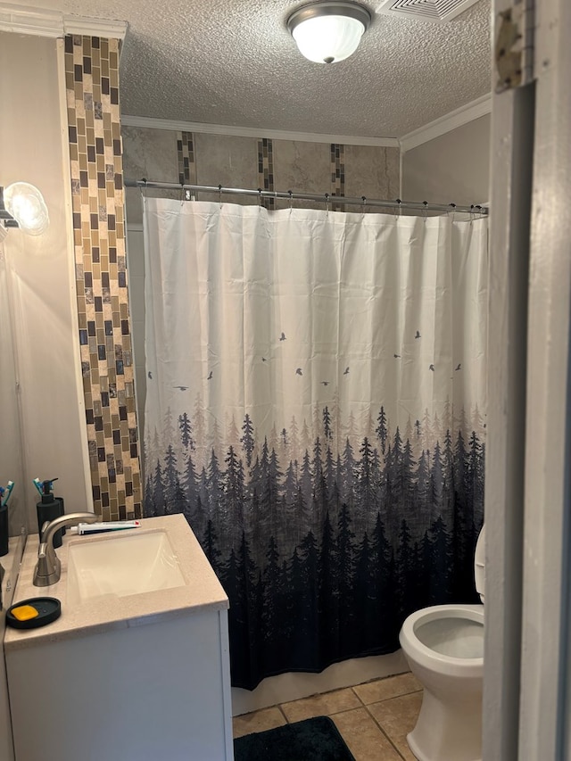 full bath featuring vanity, crown molding, a textured ceiling, and tile patterned flooring