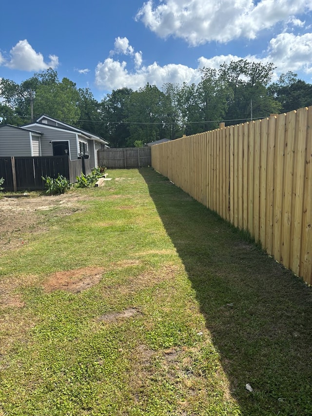 view of yard with a fenced backyard