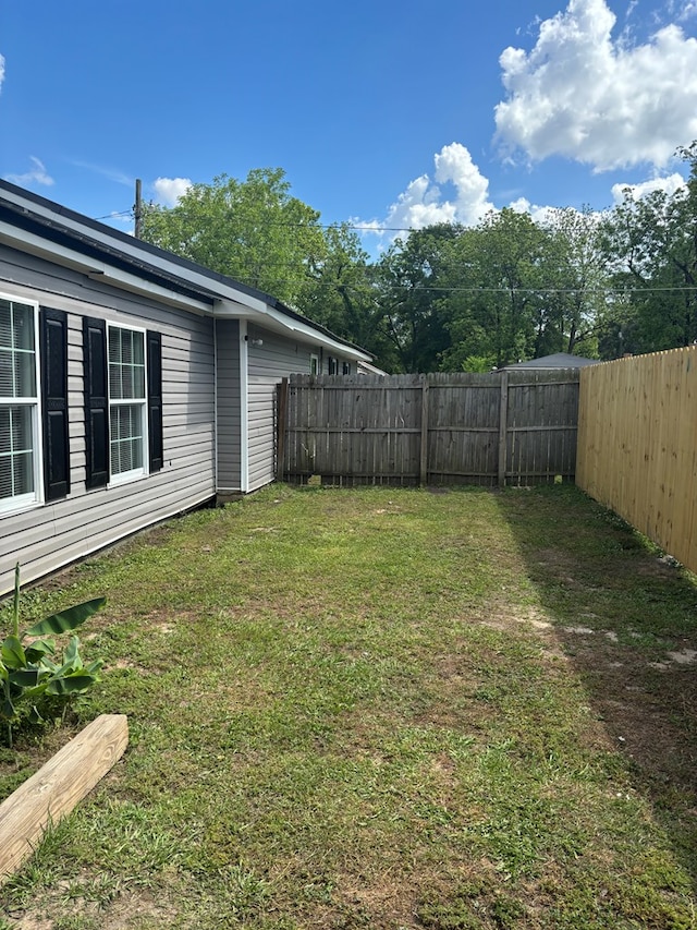 view of yard with a fenced backyard