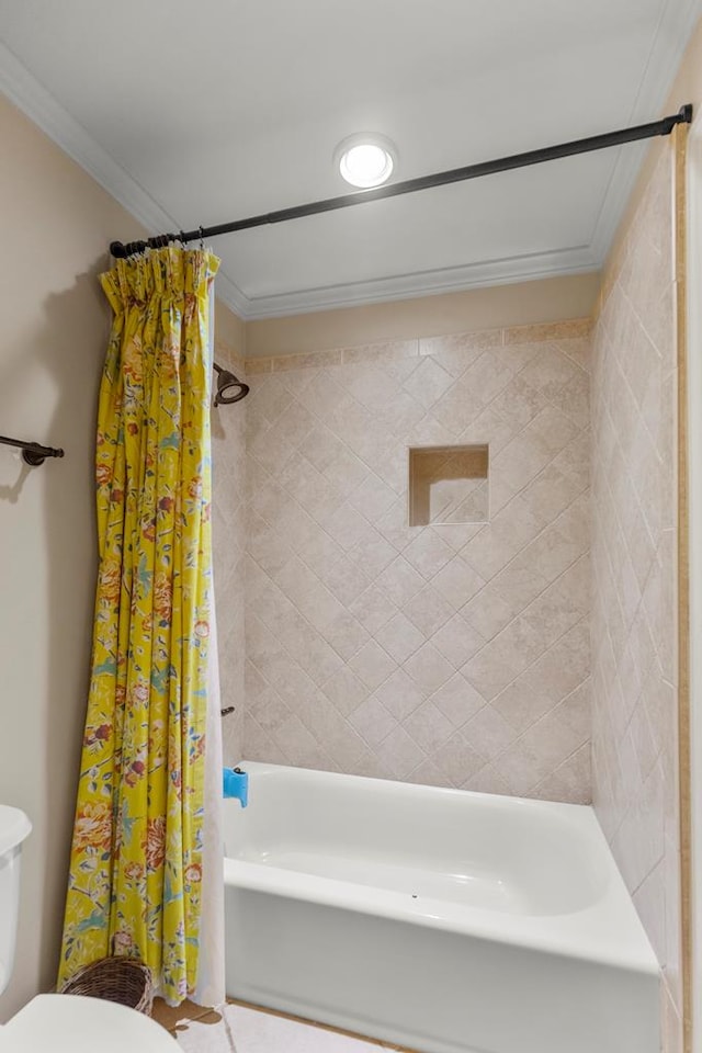 bathroom featuring shower / bath combination with curtain, toilet, and crown molding