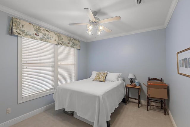 carpeted bedroom featuring ceiling fan and crown molding