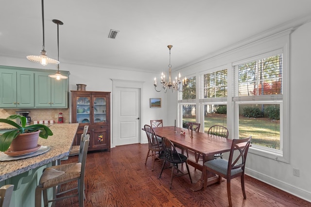 dining room featuring dark hardwood / wood-style flooring, plenty of natural light, and ornamental molding