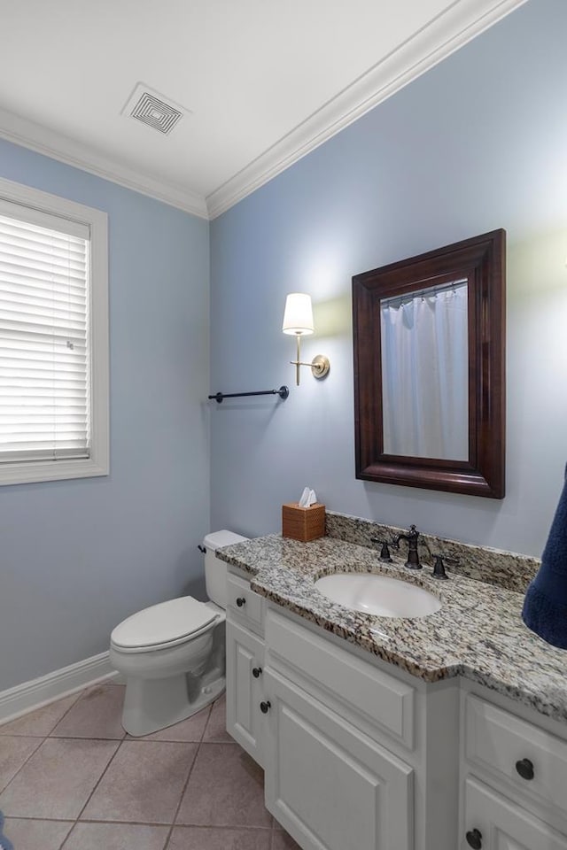 bathroom featuring tile patterned flooring, vanity, toilet, and crown molding