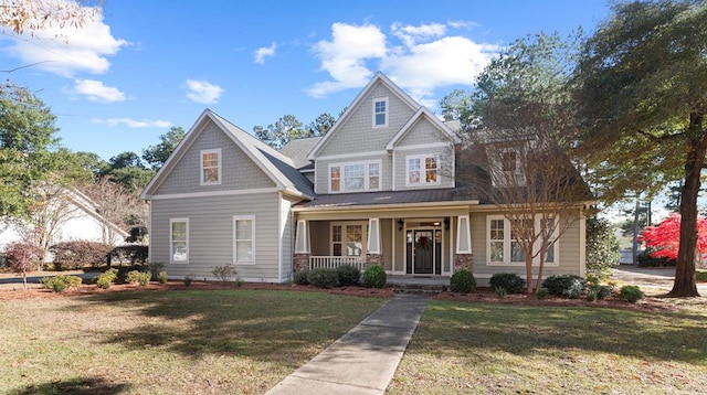 craftsman house featuring covered porch and a front yard