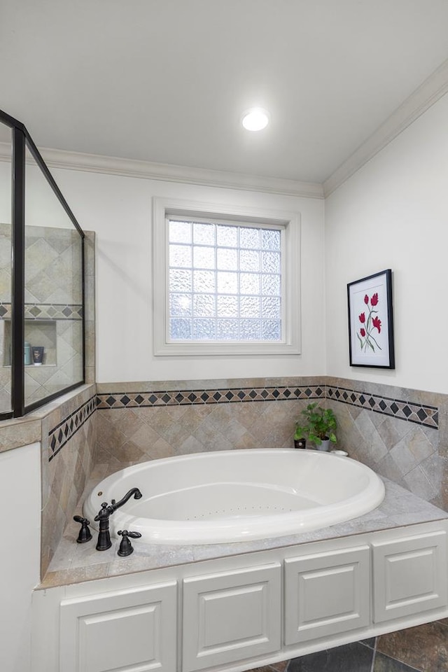 bathroom with a bathing tub and crown molding