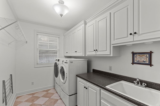 laundry area featuring washer and clothes dryer, cabinets, ornamental molding, and sink