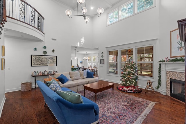 living room featuring dark wood-type flooring, a wealth of natural light, and a chandelier