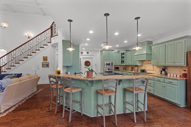 kitchen featuring pendant lighting, dark hardwood / wood-style floors, custom range hood, and appliances with stainless steel finishes