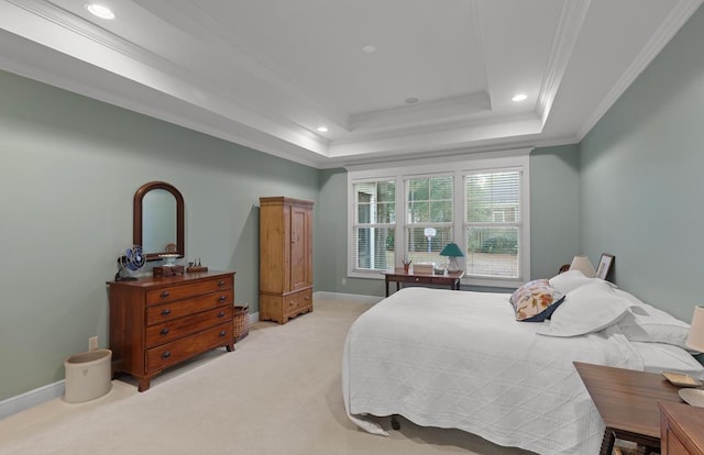 bedroom with light carpet, a tray ceiling, and crown molding