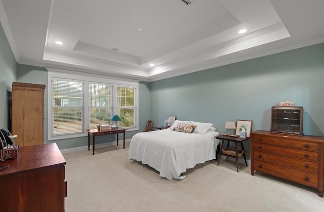 carpeted bedroom with a raised ceiling and ornamental molding