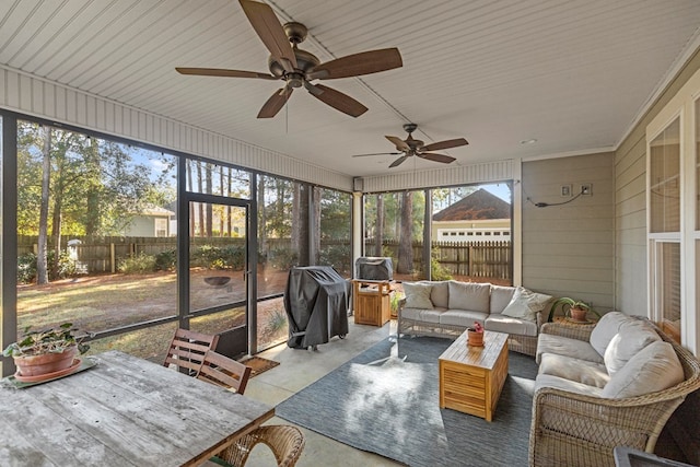 sunroom / solarium featuring ceiling fan