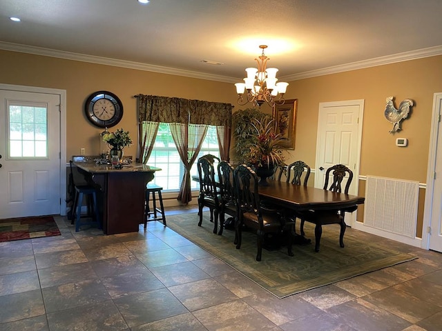 dining area with ornamental molding and a chandelier