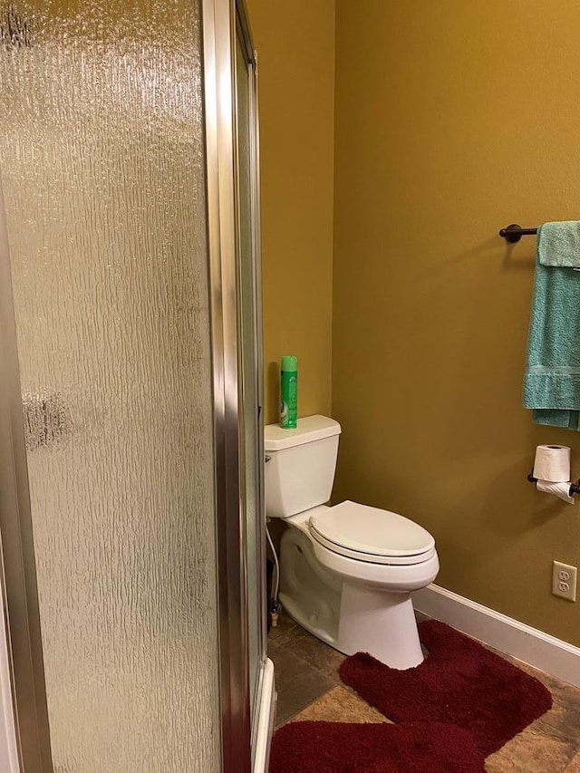 bathroom with walk in shower and toilet