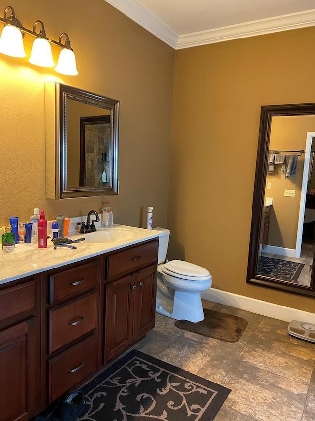 bathroom with vanity, crown molding, and toilet