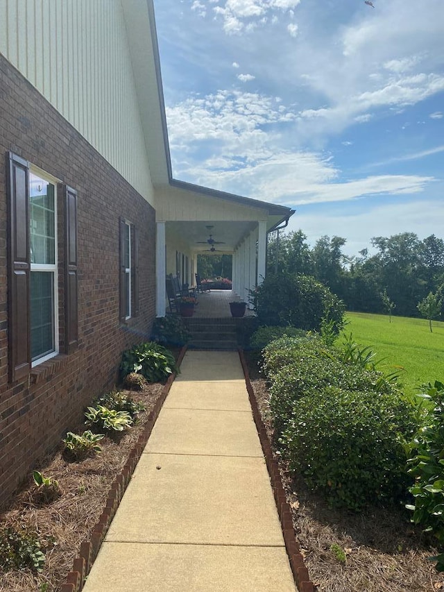 view of home's exterior with covered porch and ceiling fan