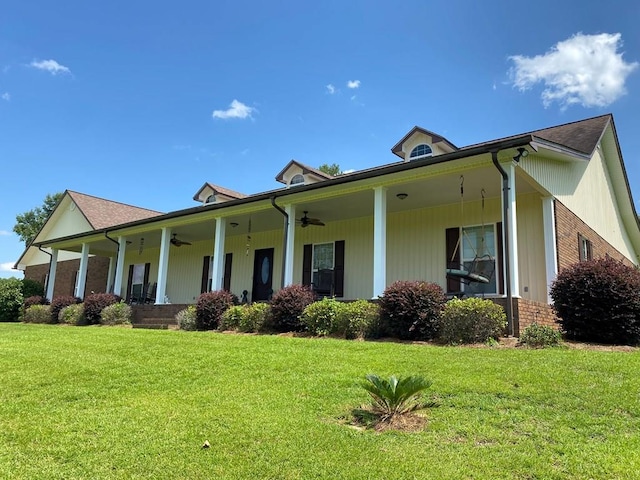 view of home's exterior featuring a lawn, ceiling fan, and covered porch