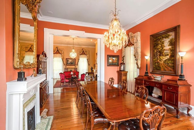 dining space with hardwood / wood-style flooring and crown molding