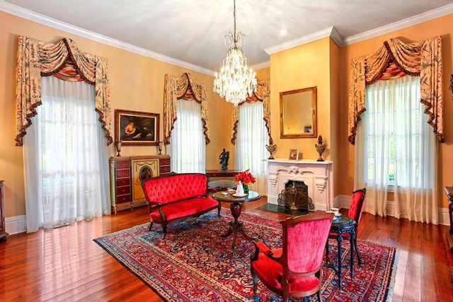 living area featuring crown molding, hardwood / wood-style floors, and a healthy amount of sunlight