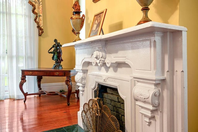 interior details featuring a fireplace and hardwood / wood-style flooring