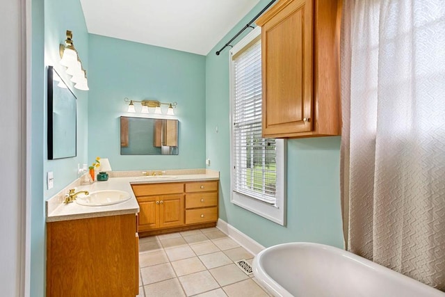 bathroom with tile patterned flooring, vanity, and a bathtub