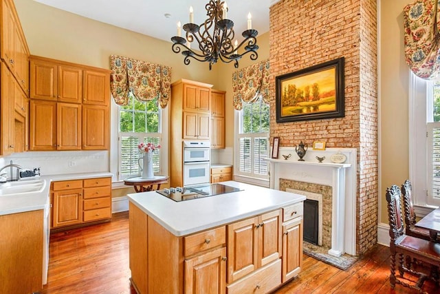 kitchen with a center island, black electric cooktop, and a wealth of natural light