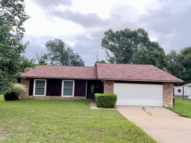 single story home with a garage and a front lawn