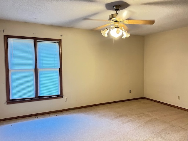 carpeted empty room with a textured ceiling and ceiling fan