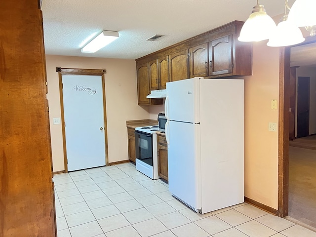 kitchen with hanging light fixtures, a chandelier, a textured ceiling, white appliances, and light tile patterned flooring