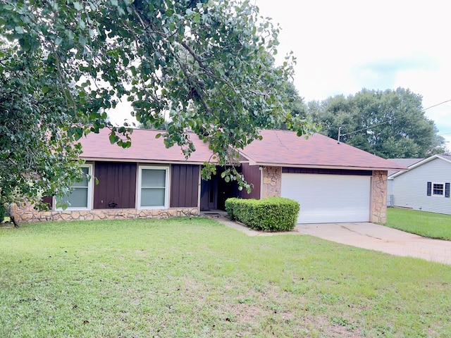 single story home featuring a front lawn and a garage