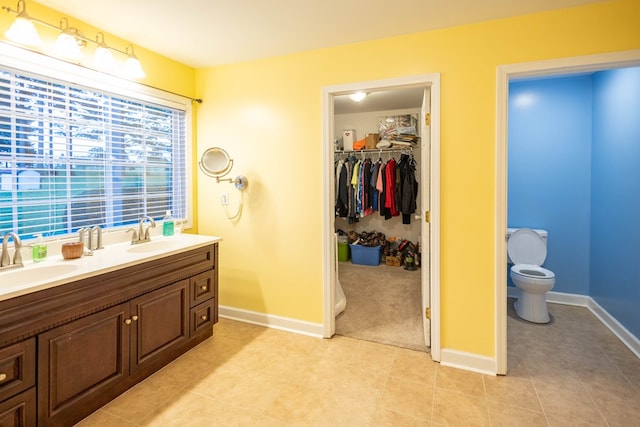 bathroom with tile patterned floors, vanity, and toilet