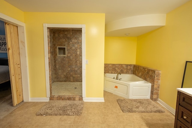 bathroom with tile patterned flooring, vanity, and shower with separate bathtub