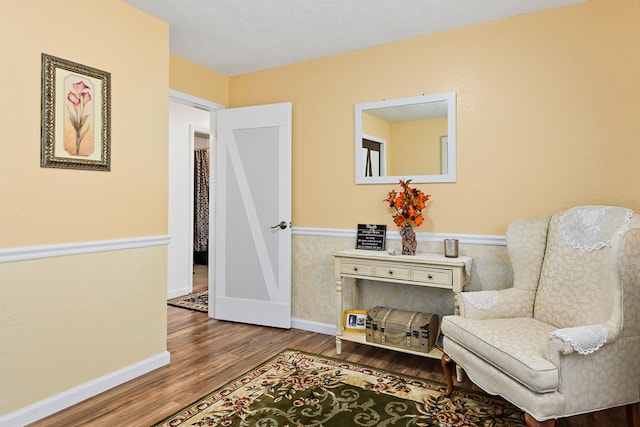 sitting room with wood-type flooring