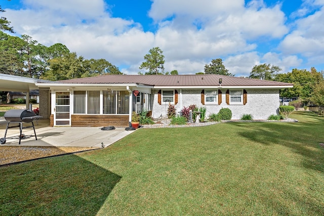 rear view of property featuring a patio area and a yard