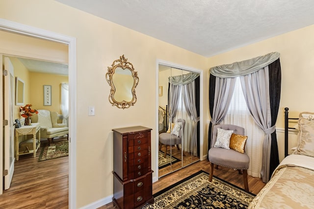 sitting room with a textured ceiling and hardwood / wood-style flooring