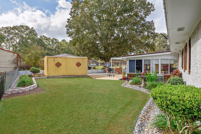 view of yard featuring a patio and a storage unit