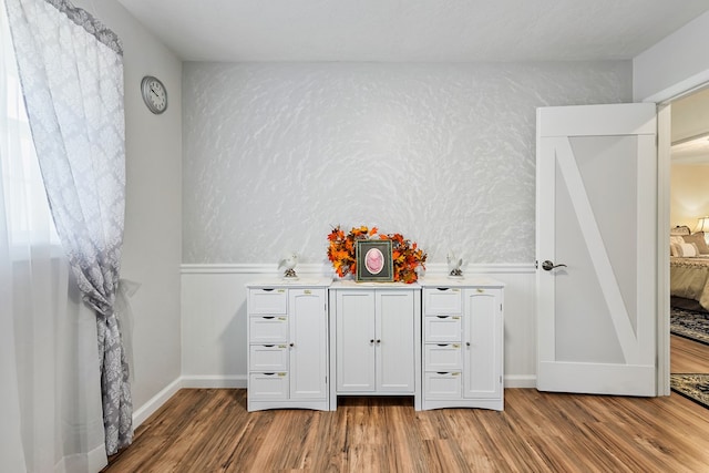 bathroom with hardwood / wood-style floors and a textured ceiling