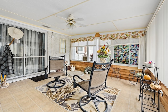 sunroom featuring ceiling fan